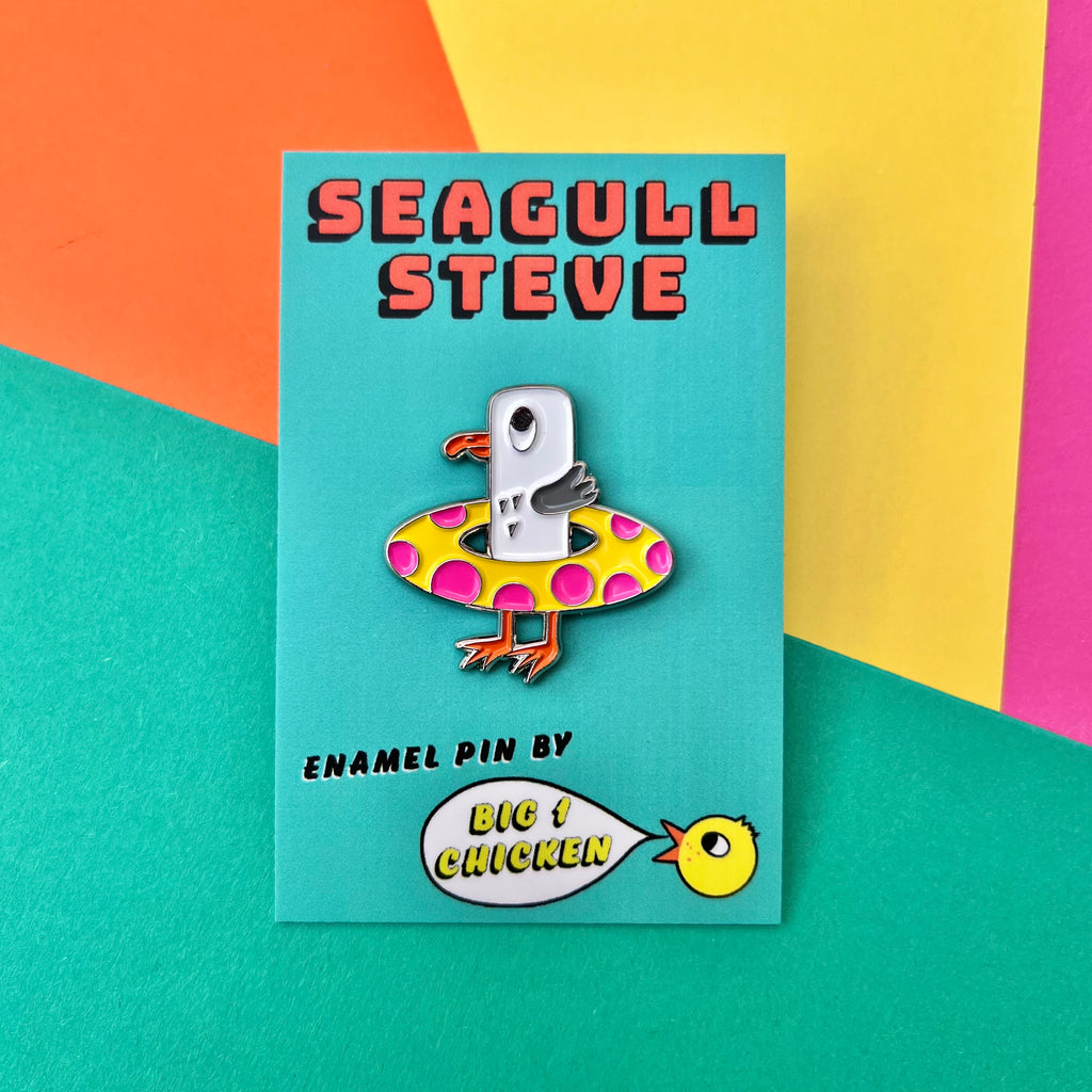 Seagull Steve soft enamel pin. He is lovely and bright and his colours are white, grey with an orange beak and feet. He has a yellow rubber ring with bright pink dots. He has a silver line around him. On back there is a yellow rubber fastener. He comes on a little big 1 chicken card with his name on it. He is approximately 3cm tall.