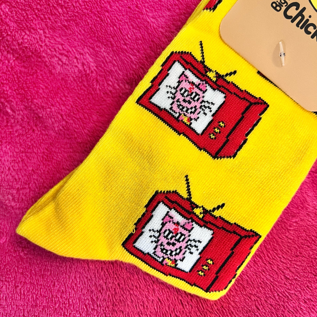 Retro Cat TV socks. A pink ice-cream cat inside a red square shaped tv. They are all over a bright yellow background of the sock. Size 36-40. Very bright. More of a close up.