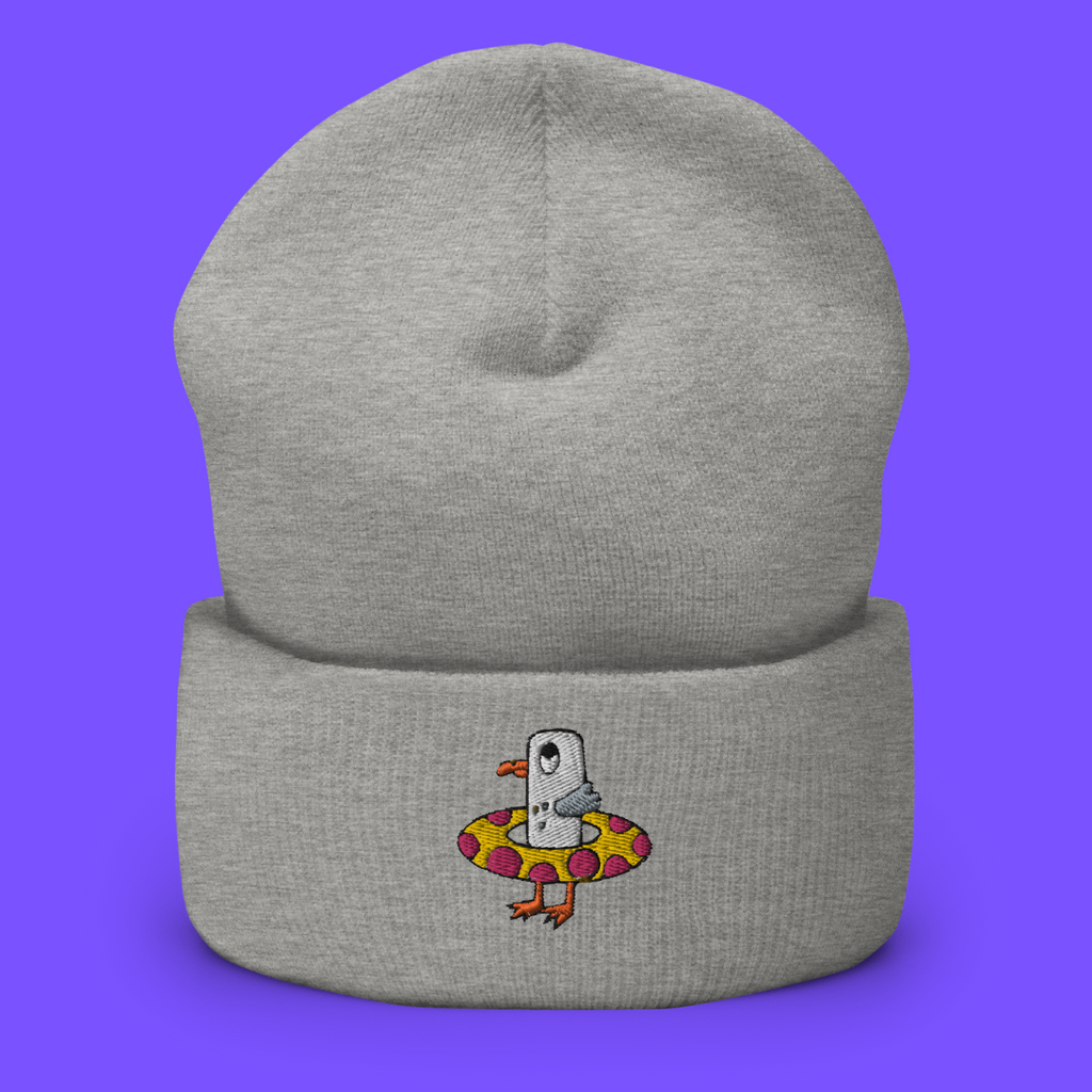 Seagull Steve is embroidered on a woolly beanie hat in a grey colour. The colour of the Seagull Steve embroidery is white, grey, black, orange, yellow and pink. Seagull Steve has big wide eyes.