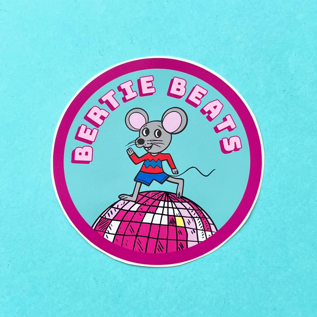 Bertie Beats is a mouse that likes a disco beat. Here you can see him running on top of a disco ball. He looks happy in his red and blue zig zag jumper. He is wearing blue shorts. There is a blue sky background and is name is in two shades of pink, pale pink with a cerise pink drop shadow. Circle sticker with a bright cerise pink thick line around the edge of the circle.Glossy finish sticker which is water resistant and approximately 88mm wide.