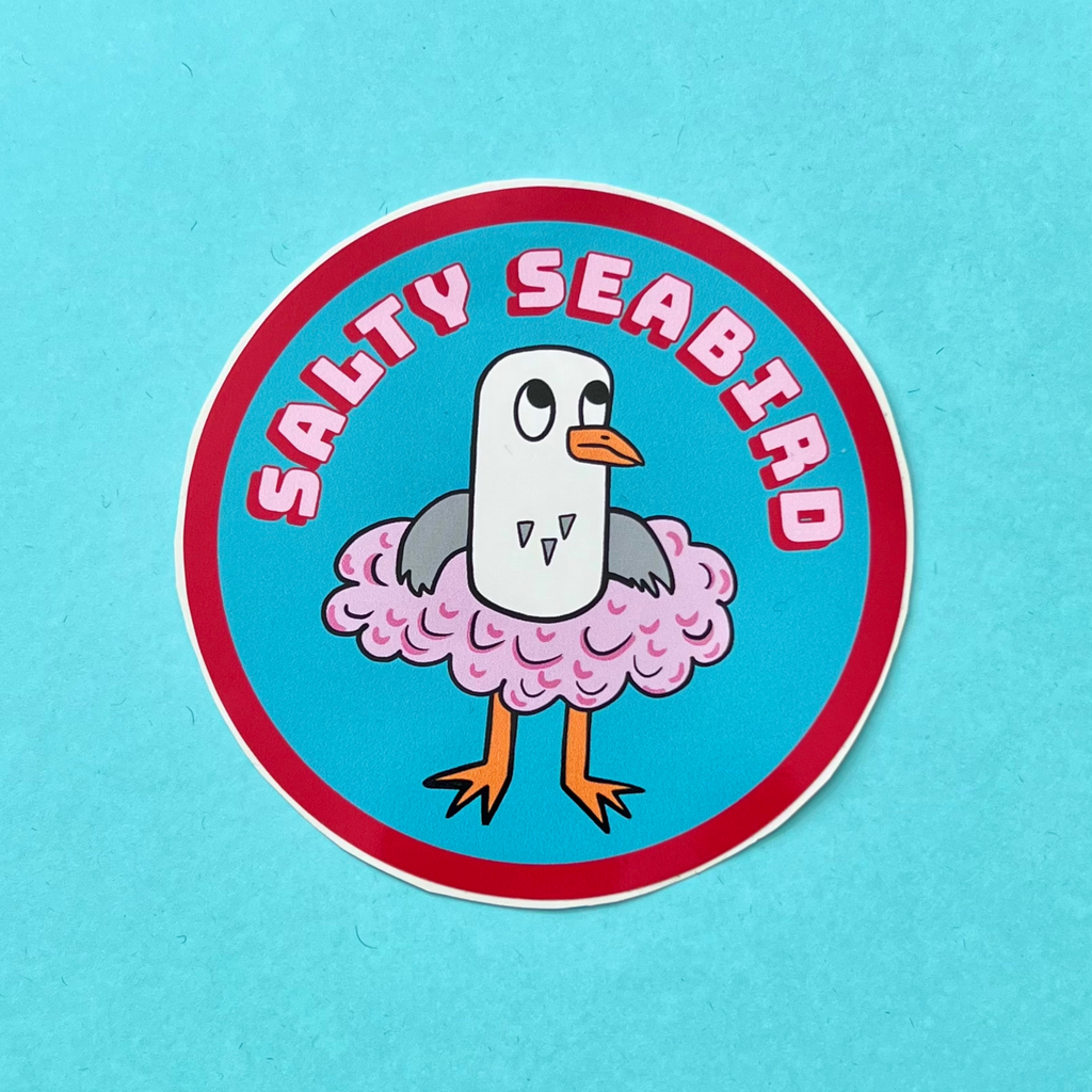 Salty Seabird is a seagull. Here she is seen in her pink tutu on a vinyl circle sticker which is approximately 88cm in diameter, it is also water resistant. She is on a nice turquoise/blue background. She is grey and white and has an orange beak and orange feet. The sticker has pink text on it that says Salty Seabird on pink with a red drop shadow, it has a red line around the circle.