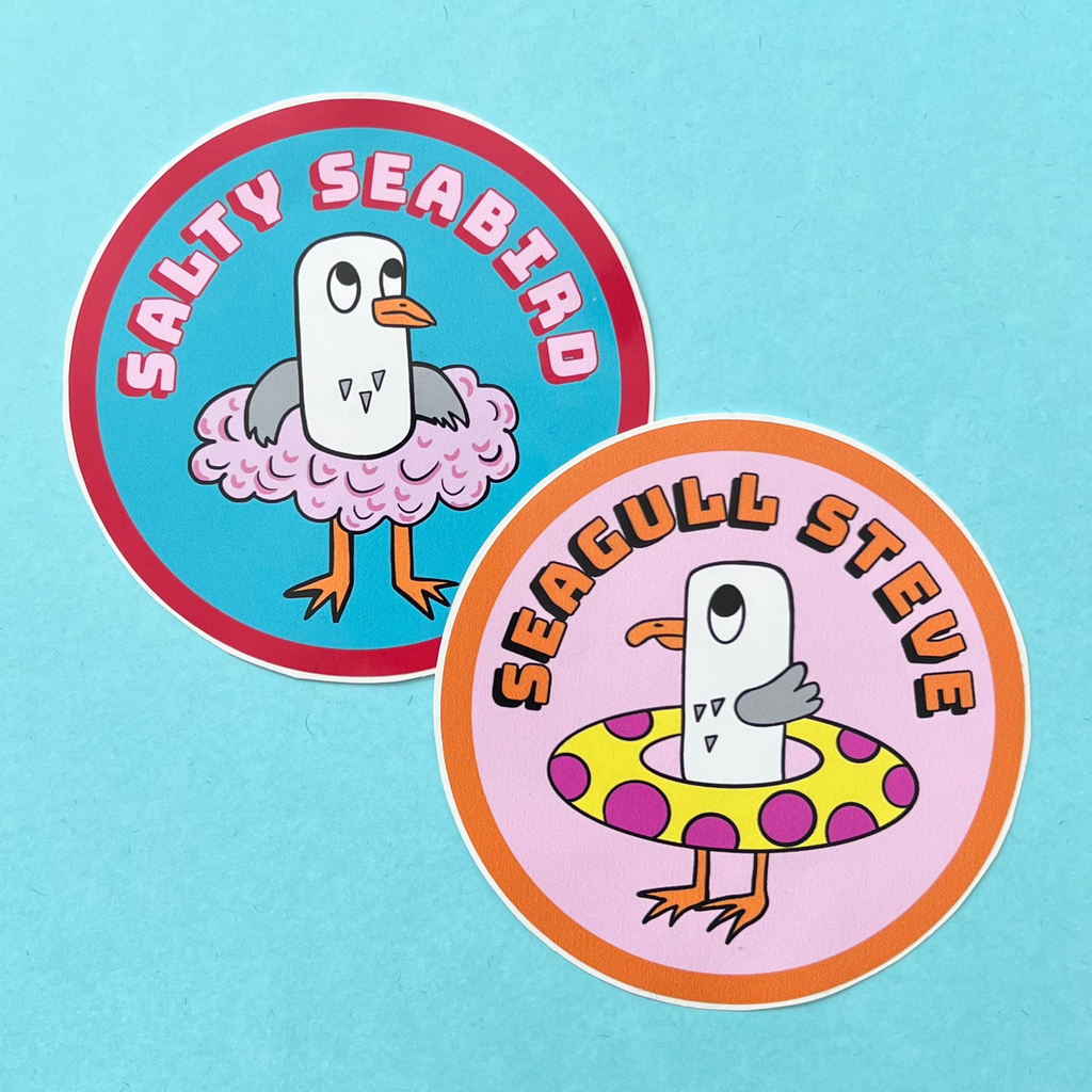 Salty Seabird is a seagull. Here she is seen in her pink tutu on a vinyl circle sticker which is approximately 88cm in diameter, it is also water resistant. She is on a nice turquoise/blue background. She is grey and white and has an orange beak and orange feet. The sticker has pink text on it that says Salty Seabird on pink with a red drop shadow, it has a red line around the circle. In this picture she is next to a circular sticker with Seagull Steve on it, he has his polka dot rubber ring with him.